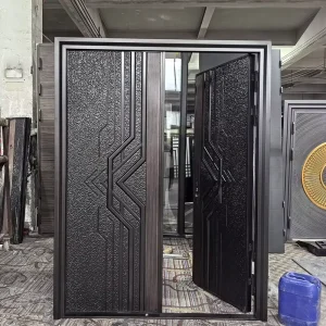 Custom-Made Single-Leaf Iron Patterned Front Entry Door for Historic Building Renovations